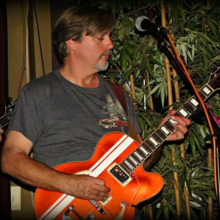 Man playing a semi-hollow body electric guitar 